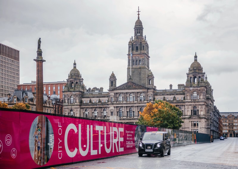 George Square Glasgow hop on hop off bus tour stop - Red Route sightseeing at city's civic heart with historic statues